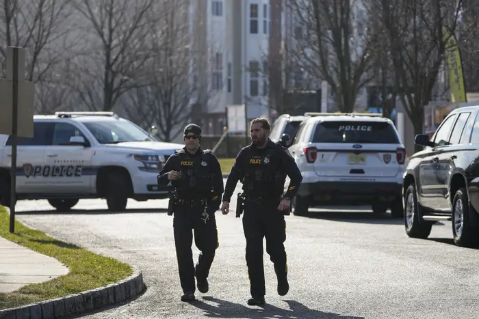 On Feb. 2, Sayreville, N.J., police officers investigate a wooded area near a townhome community, in Parlin, N.J., where Sayreville councilwoman Eunice Dwumfour was found shot to death the night before.
